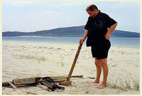 mike bannister on a beach.. with a stick